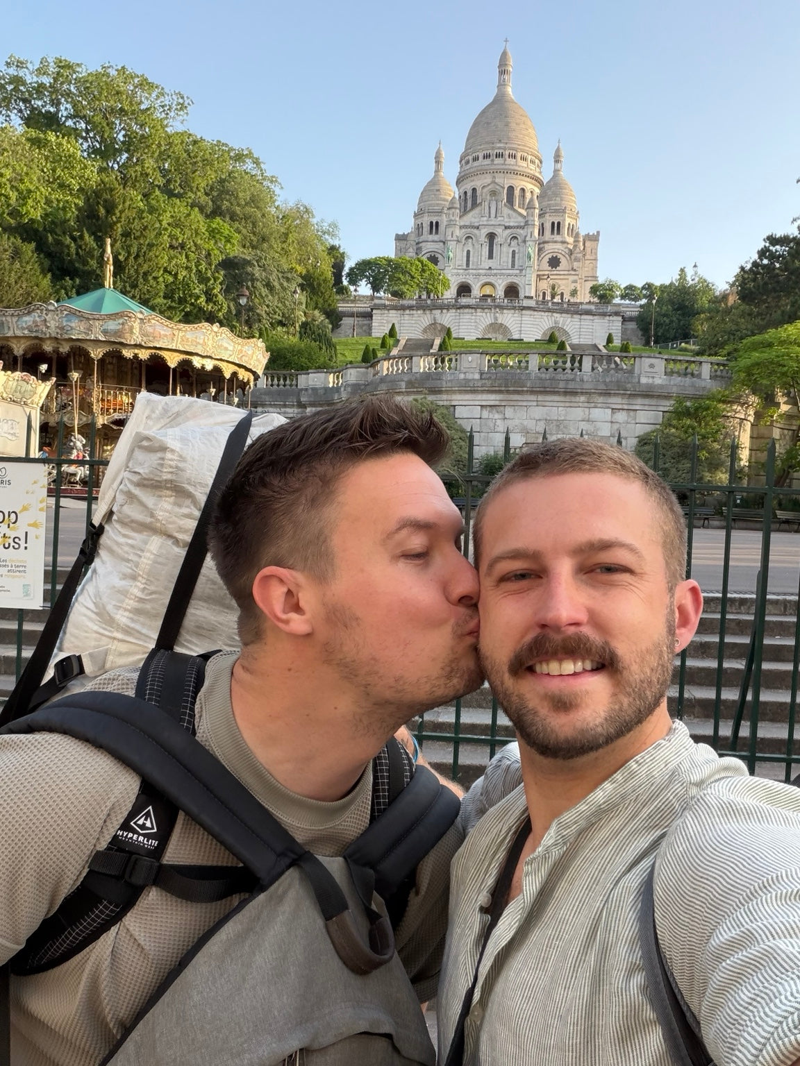 Justin being kissed on the cheek in front of Sacré-Cœur in Paris